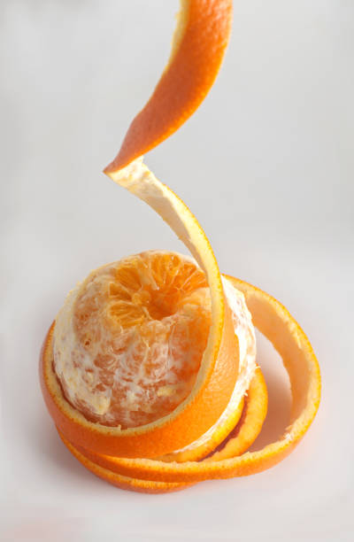 istock orange peel rings hanging down, on a gray background, spiral peel, 1151853410