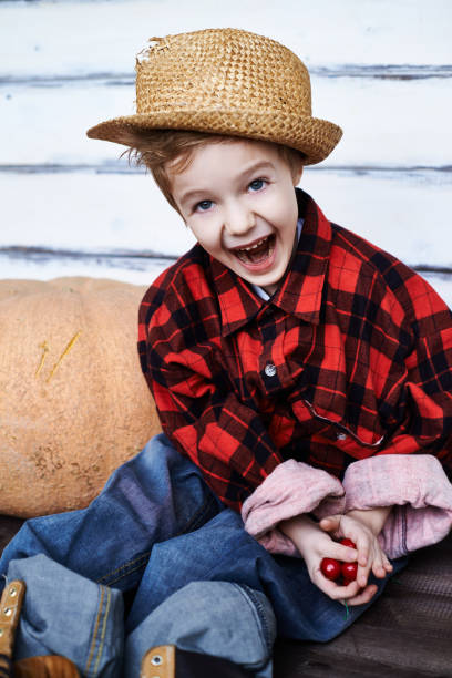 istock Expressive kid in oversize farm clothes 1151853618