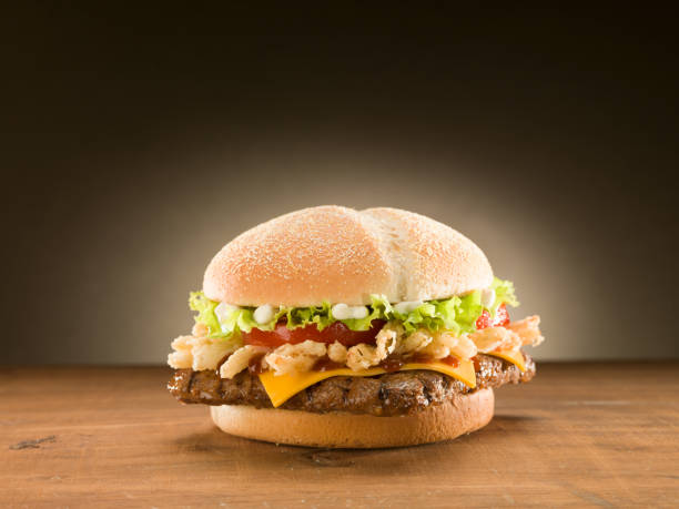 istock Cheese burger on wooden table. 1151857081