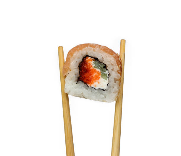 istock Traditional japanese sushi pieces placed between chopsticks, separated on white background. Very high resolution image 1151857617