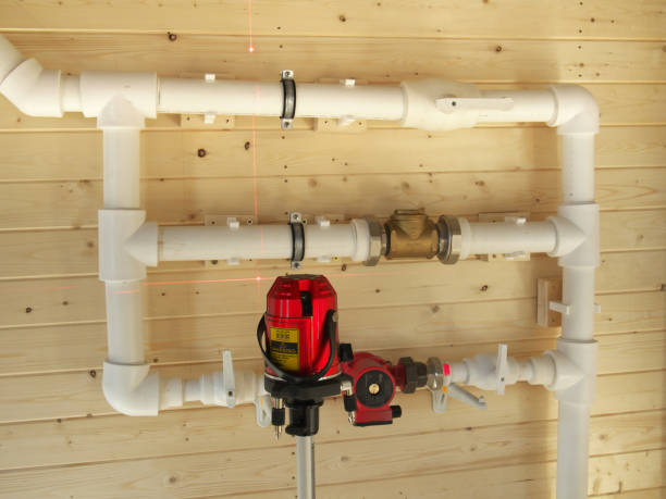istock mounting of gravity heating system equipment with laser level in a boiler room. Circulation pump, stopcock, faucet, return valve, polypropylene tube and laser level 1151860972