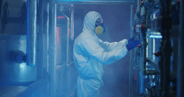 istock Scientists in hazmat suits checking equipment 1151860986
