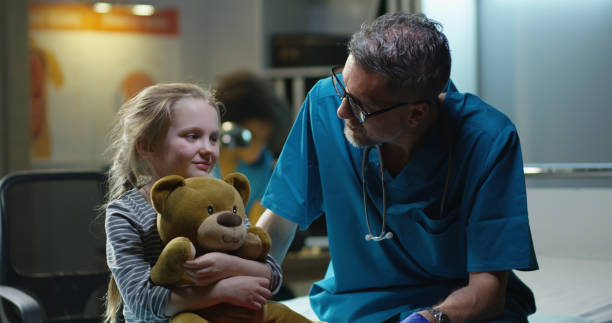 istock Friendly doctor talking with girl 1151861720