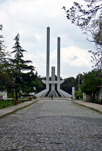 Edirne, Turkey - April 19, 2019: Treaty of Lausanne Monument at the garden of historical Edirne Train Station Building. It's dedicated to Treaty of Lausanne of 1923, in Edirne. There is a Steam power train from Orient Express era at the old railway station. Today, Trakya University is used as the fine arts academy.