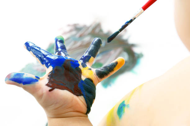 istock child paints with paint your hand. creativity and artistic hobby 1151866619