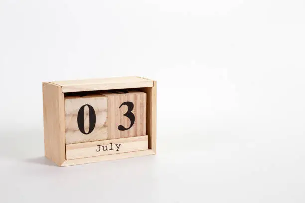 Photo of Wooden calendar July 03 on a white background