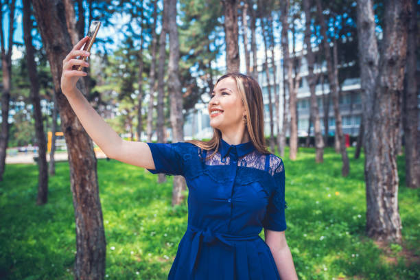 istock Smiling woman taking selfie 1151867621
