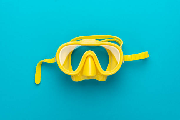 istock yellow diving mask over blue background with central composition 1151869042