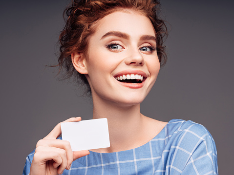 Young woman holding a business card