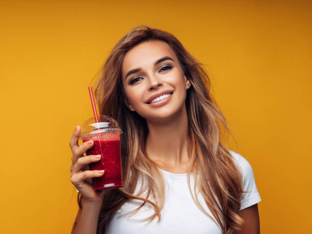 istock Beautiful girl drinks smoothies 1151869908