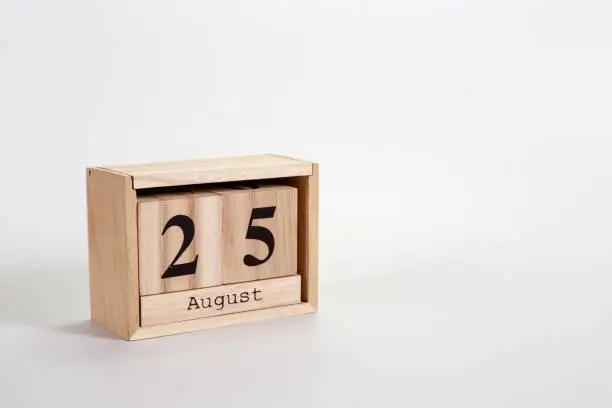 Wooden calendar August 25 on a white background close up