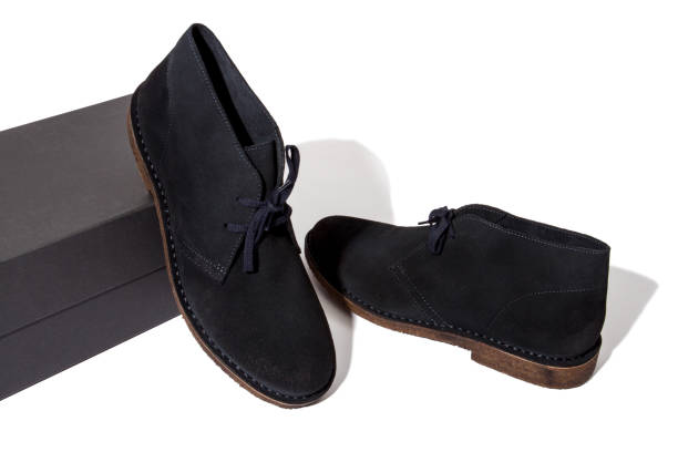 istock dark blue colored suede desert boots standing on black shoebox 1151872085