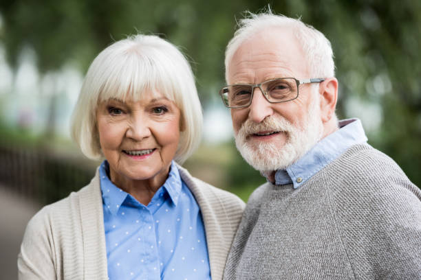 istock happy senior couple smiling and looking at camera 1151872267