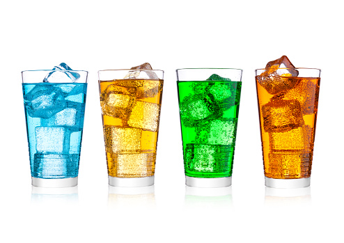 Glass of energy carbonated soda drink with ice on white background.Blue, orange and green color
