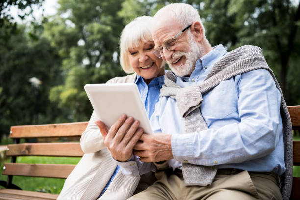 istock happy smiling senior couple using digital tablet together 1151874206