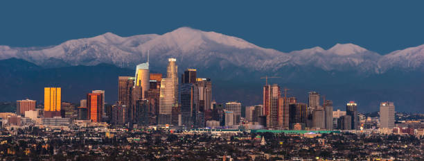 istock Downtown Los Angeles skyline with snow capped mountains behind at twilight 1151875016