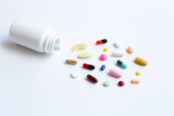 istock Colorful tablets with capsules and pills on white. 1151877250