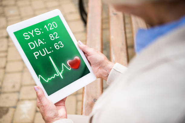istock selective focus of senior woman using digital table with heartbeat rate on screen 1151879194