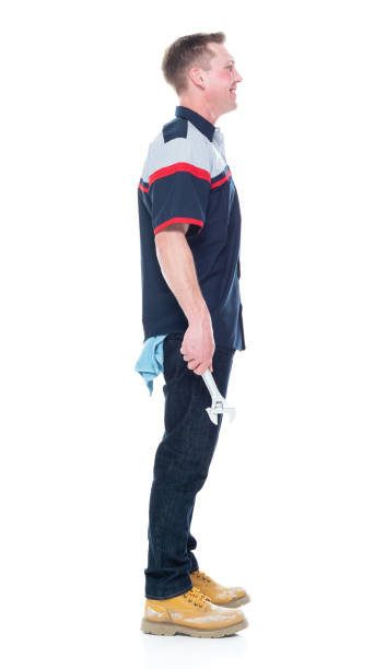istock Young handsome male mechanic standing on white background - hands by side 1151880076