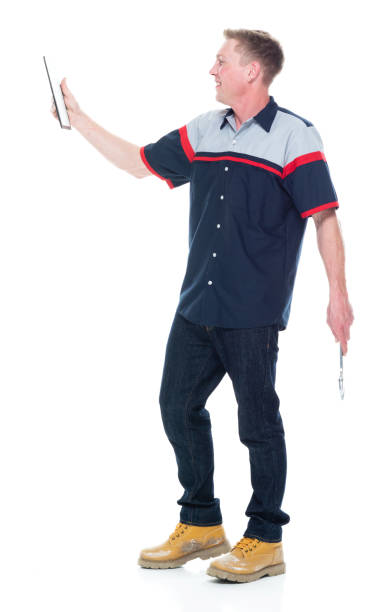 istock Young handsome male mechanic standing on white background - using tablet 1151880214