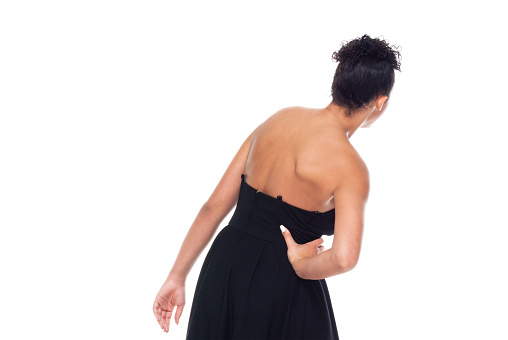Good looking attractive black female wearing a dress - backache