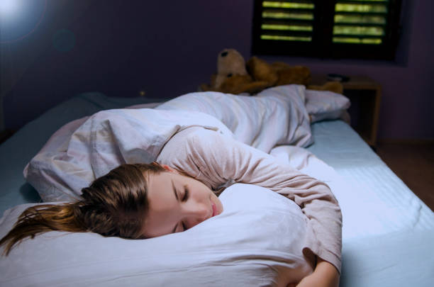 istock Child girl peaceful sleeping in her bed. 1151883191