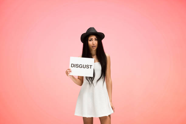 istock Beautiful female on pink background is feeling digusted 1151883375
