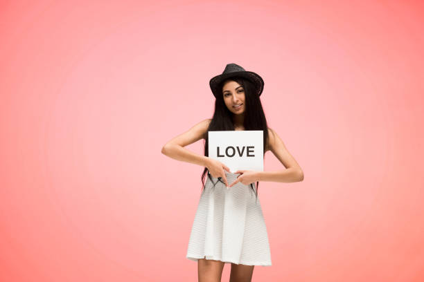 istock Beautiful female on pink background is feeling loved 1151883992
