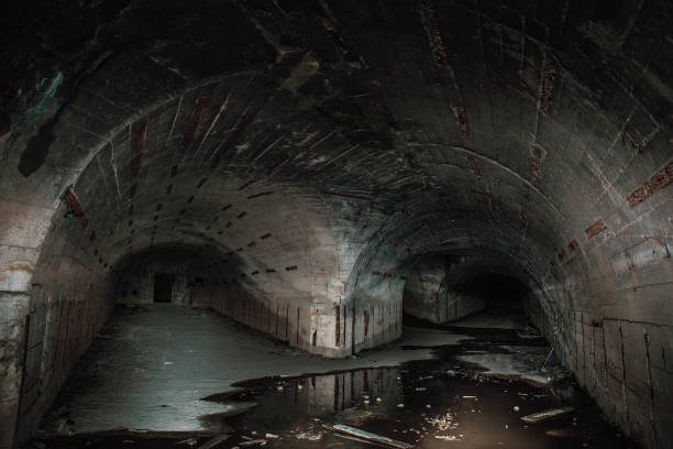 istock Two ways in long underground concrete corridors or tunnels in abandoned bunker or nuclear shelter 1151885306