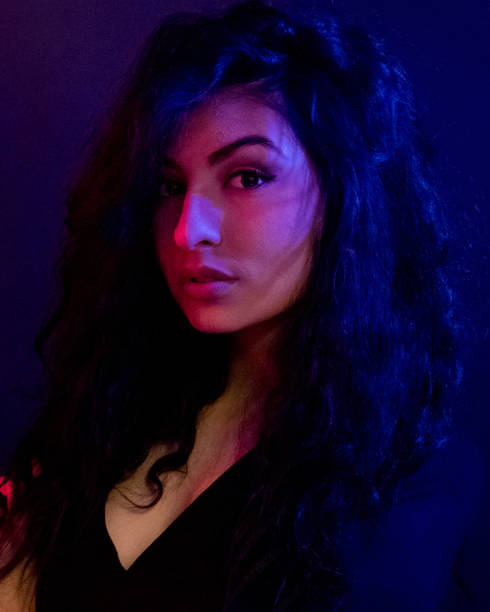 istock Attractive female in blue and red light 1151886147