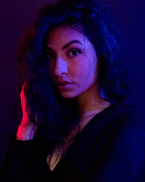 istock Attractive female in blue and red light 1151886174