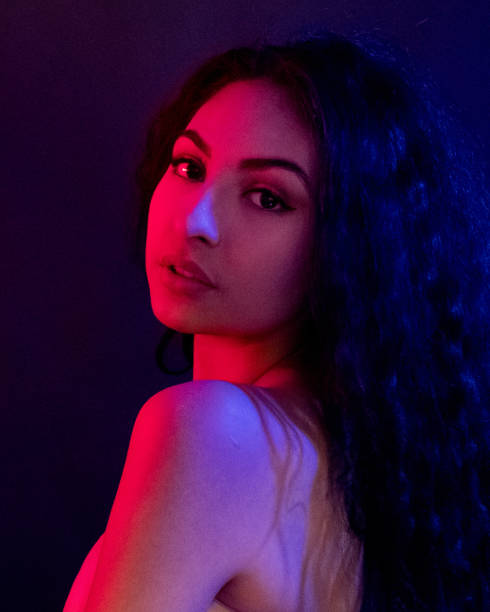 istock Attractive female in blue and red light 1151886175