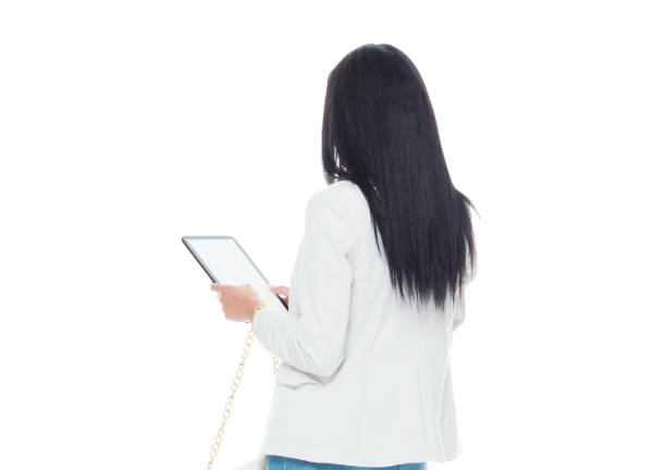 Beautiful latino female wearing a jacket and jeans - using tablet