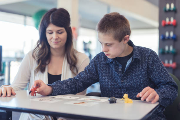 istock Speech therapist works with a young boy 1151887494