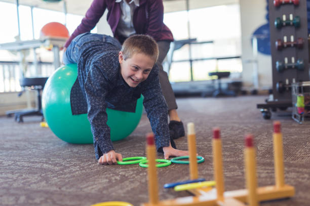 istock A boy does workouts with an occupational therapist at a physiotherapy clinic 1151887501