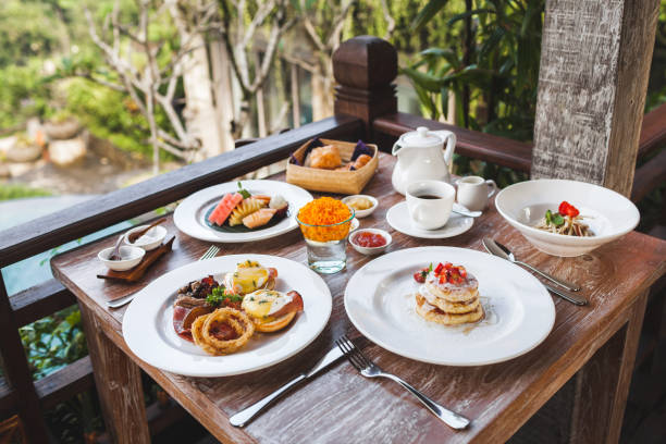 istock English breakfast with eggs benedict and strawberry pancakes on wooden table 1151887738