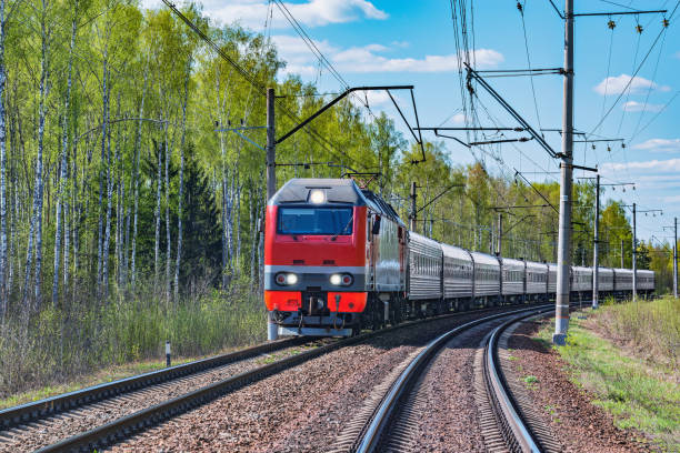 Passenger train approaches to the station. Passenger train approaches to the station at spring day time. intercity train photos stock pictures, royalty-free photos & images