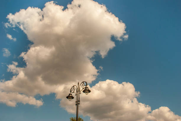 Metal old-fashioned lamppost against blue sky