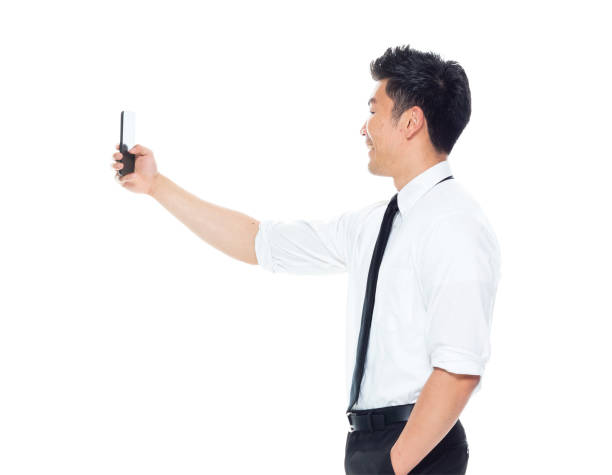 istock Handsome Asian Businessman - taking a selfie 1151888386