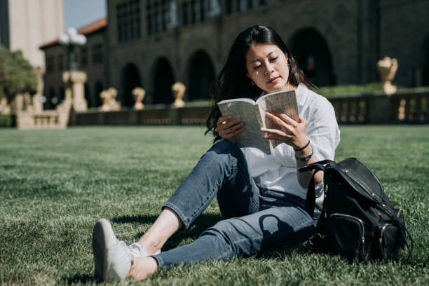 istock asian student reading book at school park 1151890355