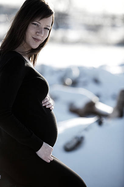 istock young pregnant woman in snow 115189821