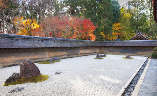 Japanese rock garden in Ryoanji Temple Kyoto, Japan - Dec 1, 2017: Dry landscape Japanese garden with rocks and colorful maple trees in Ryoanji Temple rinzai zen buddhism stock pictures, royalty-free photos & images