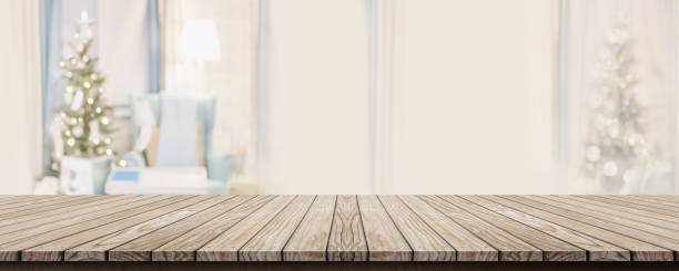 istock Empty wold plank table top with abstract warm living room decor with christmas tree blur background with bokeh light,Holiday backdrop,Mock up banner for display of advertise product ,luxury house 1151903350