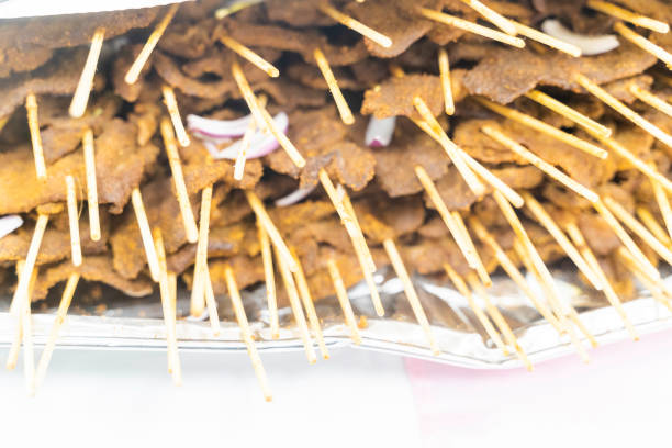 Nigerian pepper beef suya on stakes at party - a popular snack