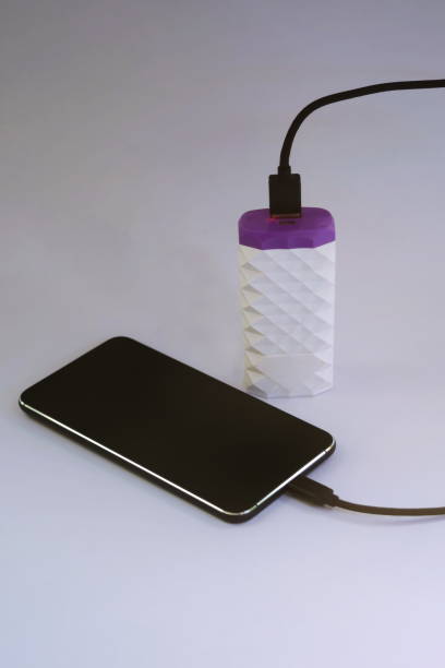 istock The phone is charging with a power bank on a white background. 1151920469