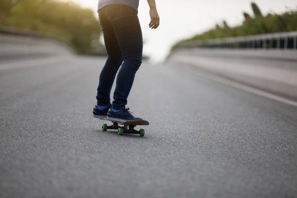 istock Skateboarder legs skateboarding on city road 1151921549