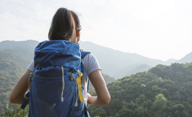 istock woman backpacker enjoying the view on morning mountain valley 1151921654