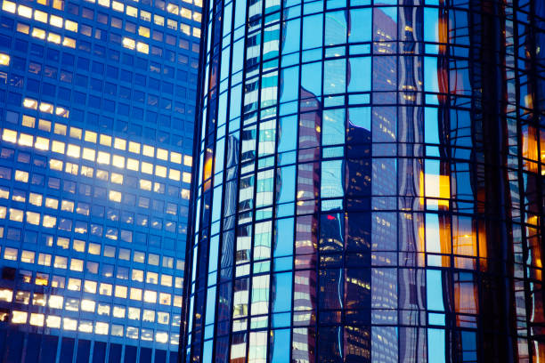 istock Illuminated Office building at night with reflection and lights 1151921817