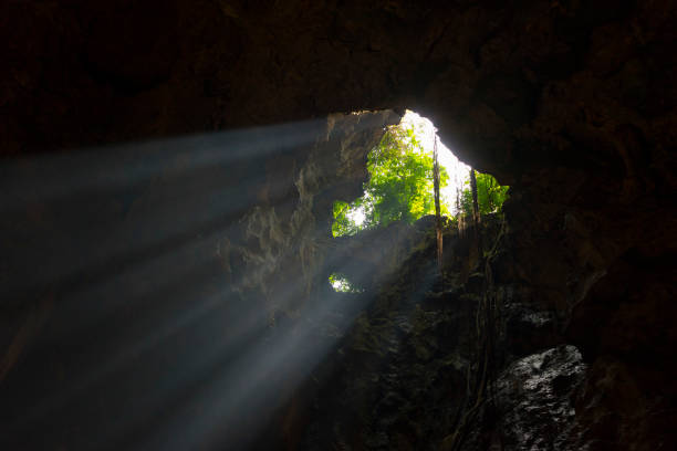 istock Sunlight burst from top of underground cave. 1151922639