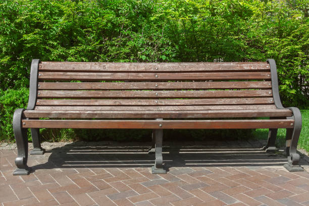 istock Wooden Old Bench in Retro Style in Public Park 1151925346